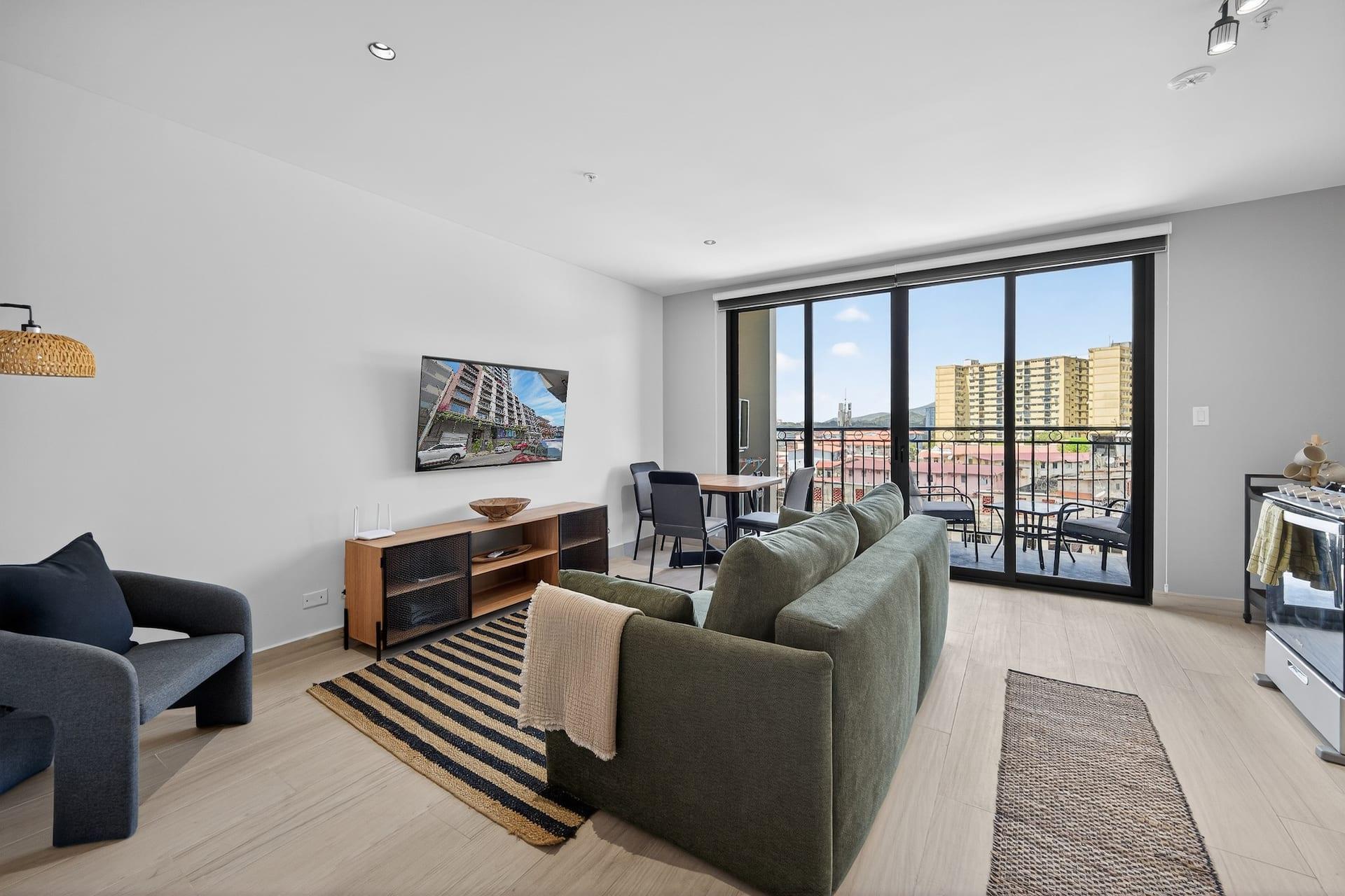 The living room with floor to ceiling windows onto the balcony